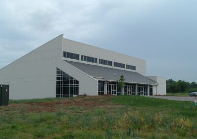 A white building on a grassy field.